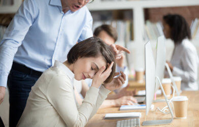 Woman getting yelled at by boss at work