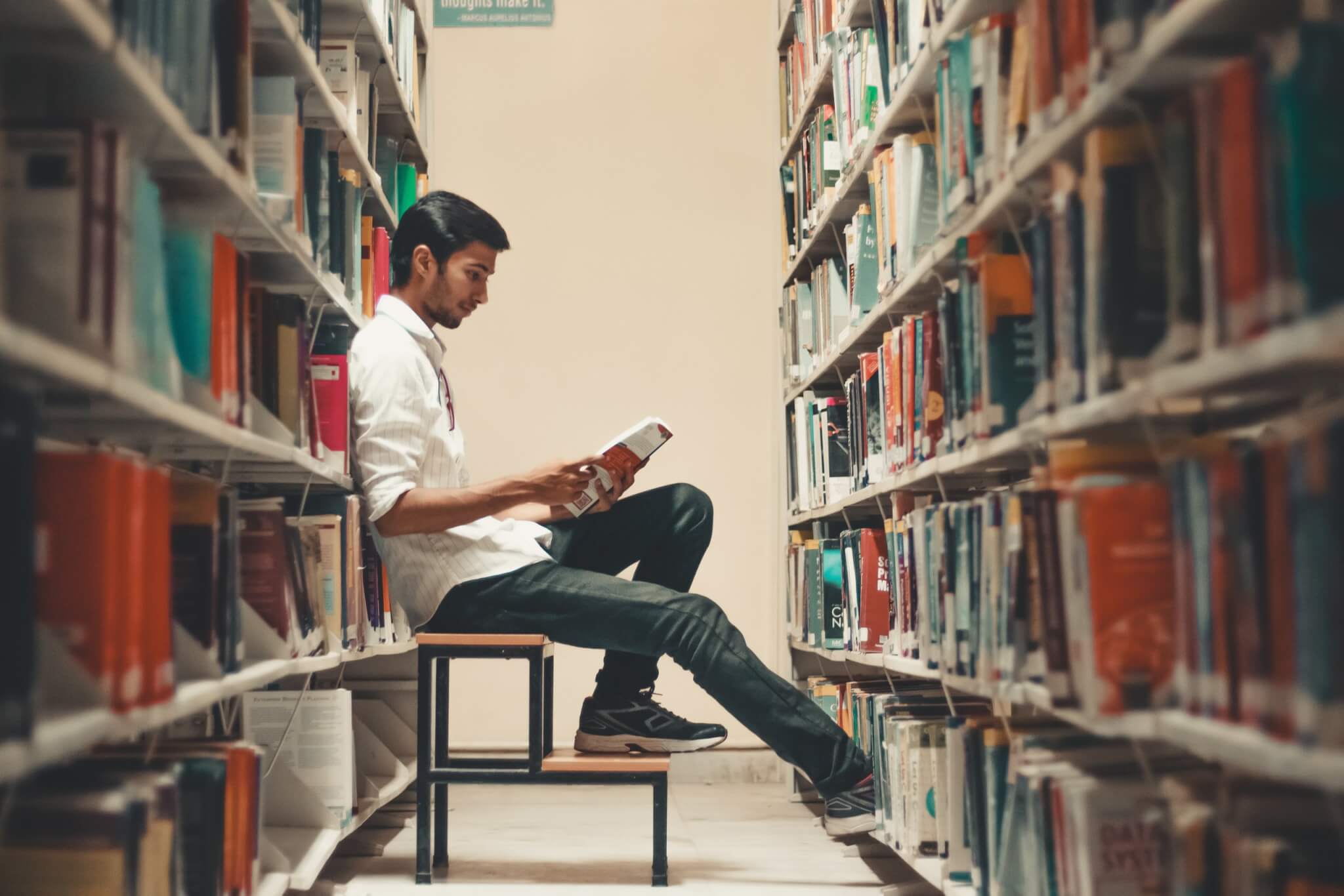 Man reading book in library