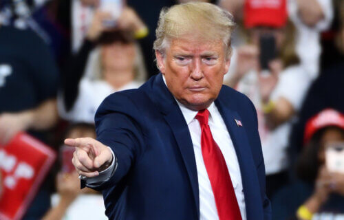 President Donald Trump gestures the pointing finger to his supporters during a campaign rally