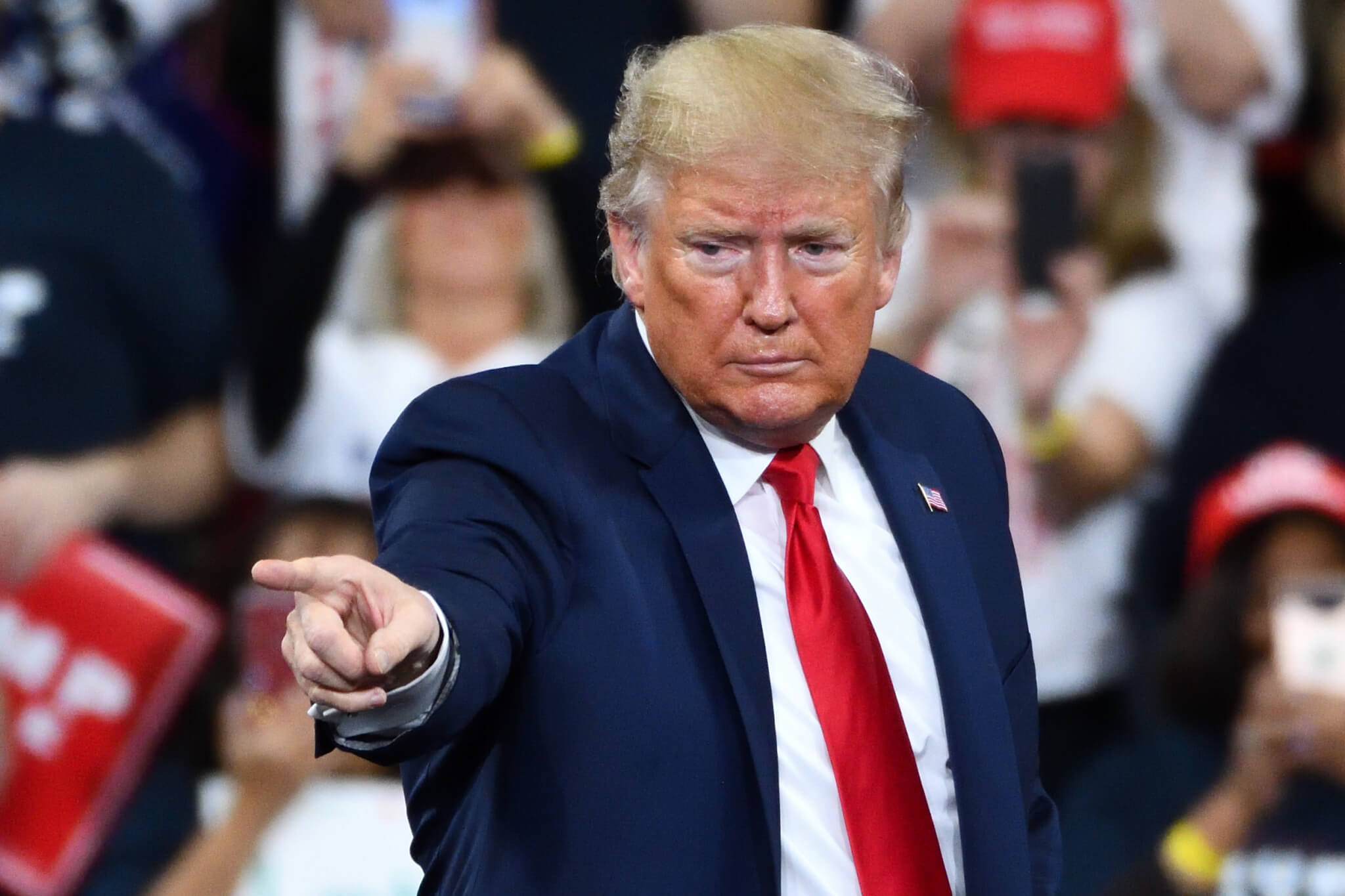 President Donald Trump gestures the pointing finger to his supporters during a campaign rally