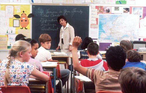 a student raising their hand in class