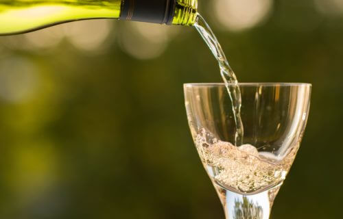 White wine being poured from bottle