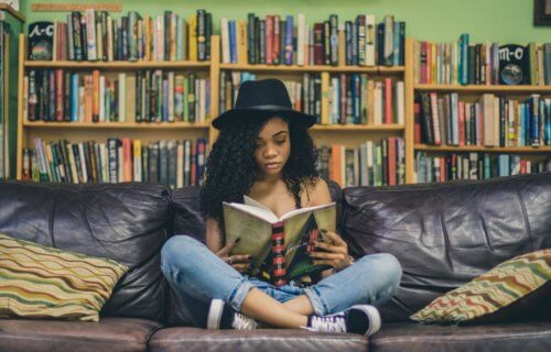 Woman reading book at bookstore or library