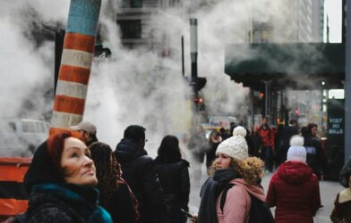 people standing in city smog steam