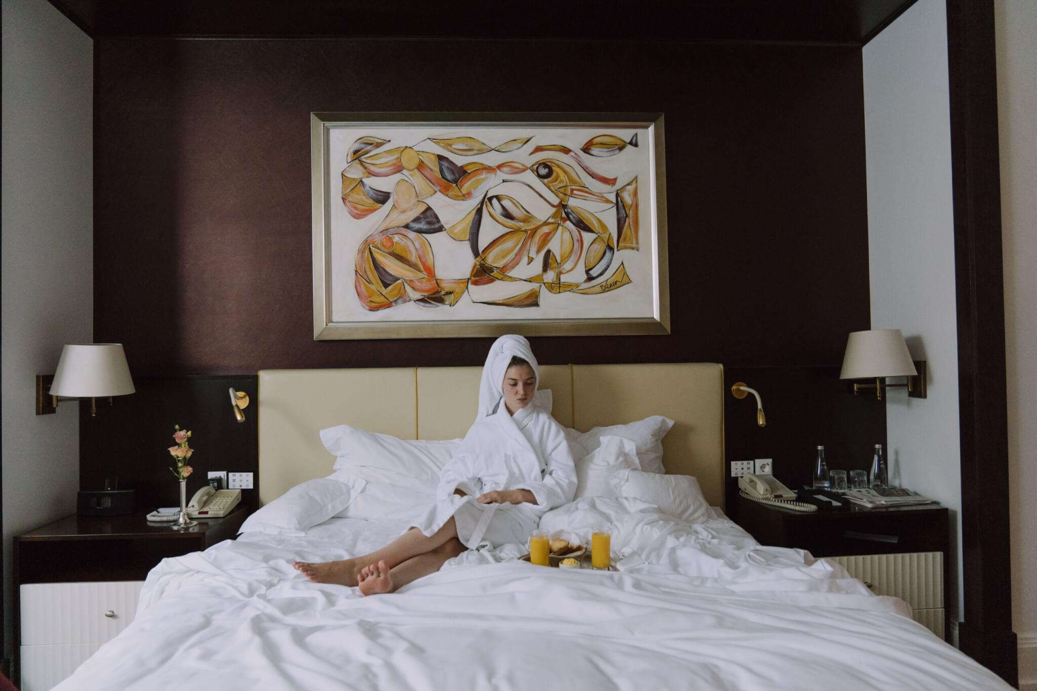 Woman laying in hotel room bed